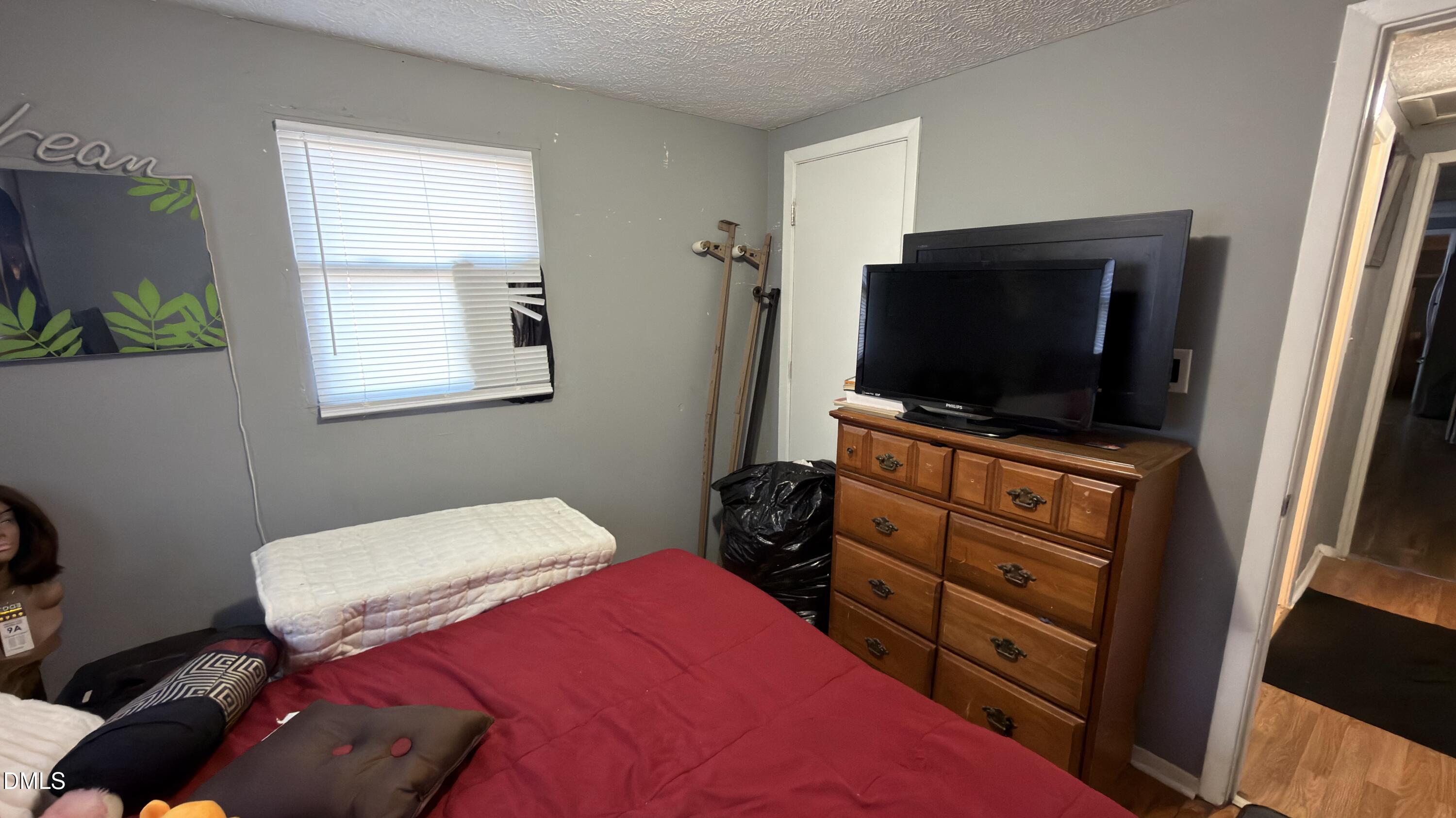 4803 Tabor Church Road Fayetteville, NC 28312 - Photo 15 of 25 a bedroom with a bed and a flat screen tv