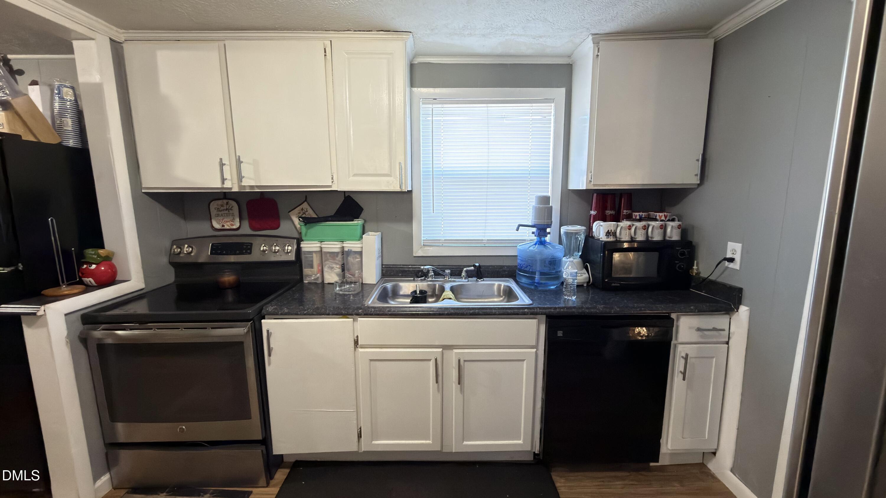 4803 Tabor Church Road Fayetteville, NC 28312 - Photo 9 of 25 a kitchen with white cabinets and appliances
