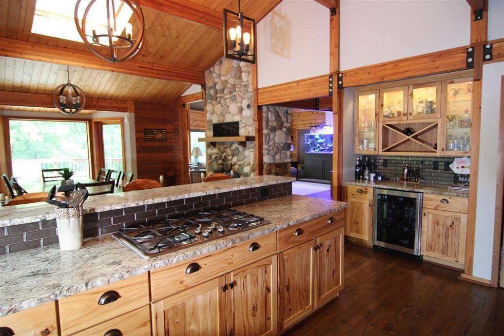 6492 Fitzgerald Road Rockford, IL 61102 - Photo 13 of 44 a kitchen with stainless steel appliances granite countertop a stove a sink and a microwave