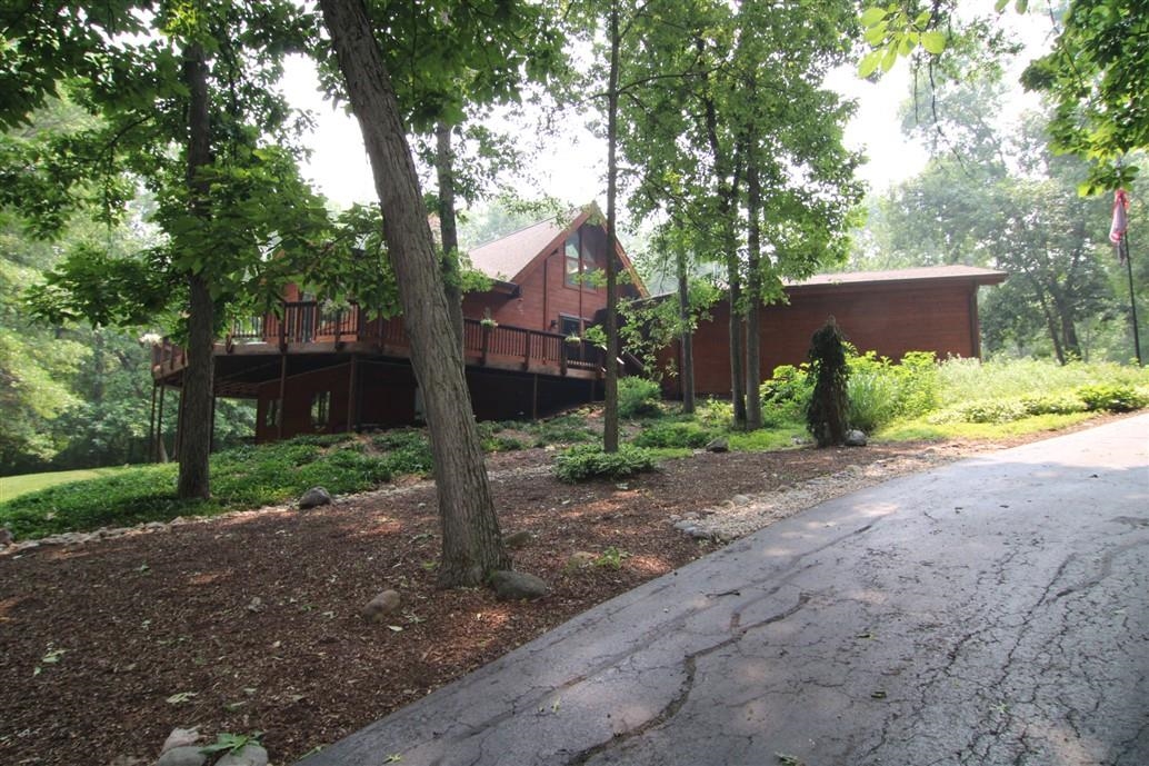 6492 Fitzgerald Road Rockford, IL 61102 - Photo 2 of 44 a front view of a house with garden and trees