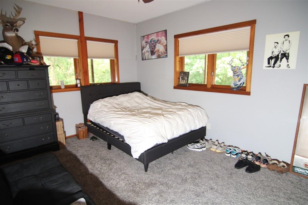 6492 Fitzgerald Road Rockford, IL 61102 - Photo 32 of 44 a bed sitting in a bedroom next to a window