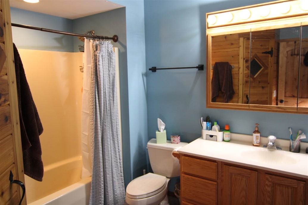 6492 Fitzgerald Road Rockford, IL 61102 - Photo 34 of 44 a bathroom with a granite countertop sink toilet and shower