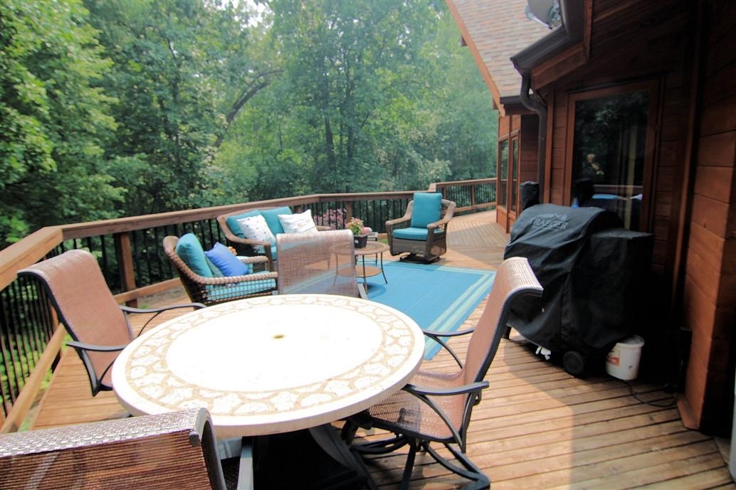6492 Fitzgerald Road Rockford, IL 61102 - Photo 7 of 44 a outdoor sitting area with furniture and wooden floor