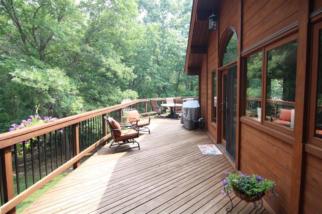 6492 Fitzgerald Road Rockford, IL 61102 - Photo 8 of 44 a view of balcony with couch and wooden floor