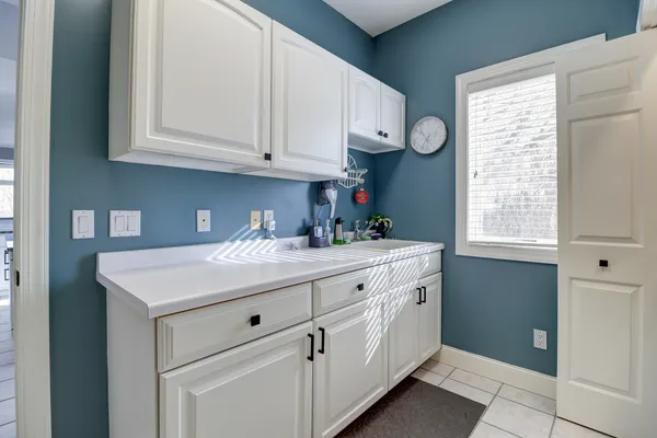 a utility room with cabinets washer and dryer