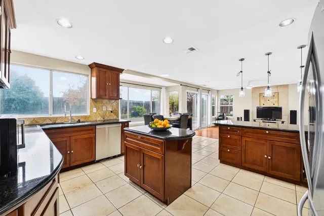 a kitchen with stainless steel appliances granite countertop a stove and a sink