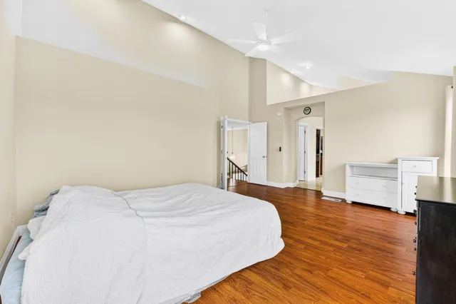 a large bedroom with a large bed and a window