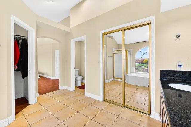 a room with a bed and wooden floor