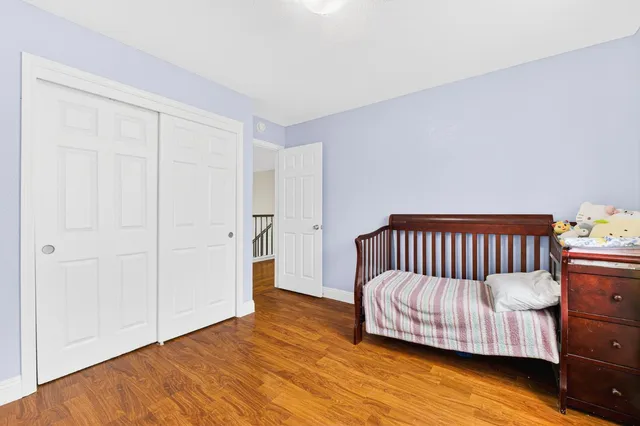 a bedroom with a bed and a night stand