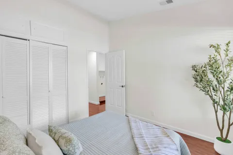 a bedroom with a bed and a potted plant