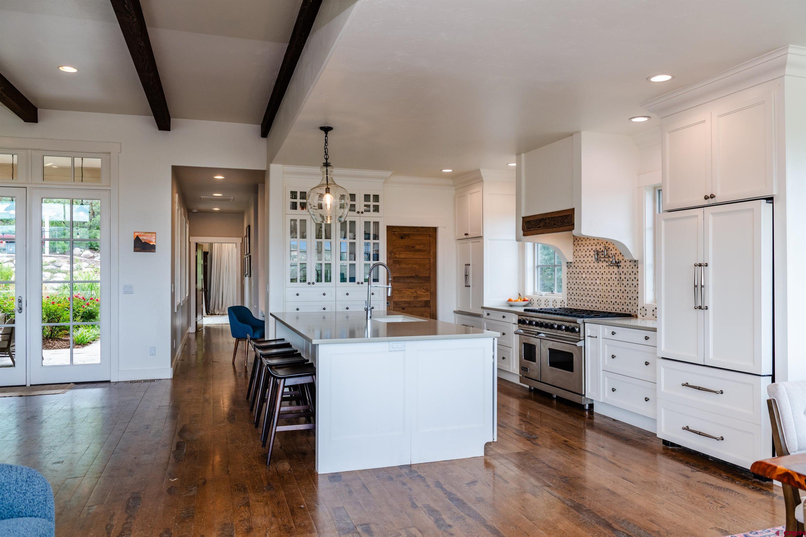 22 Kennebec Drive Durango, CO 81301 - Photo 11 of 34 a kitchen with stainless steel appliances granite countertop a stove refrigerator and a wooden floor