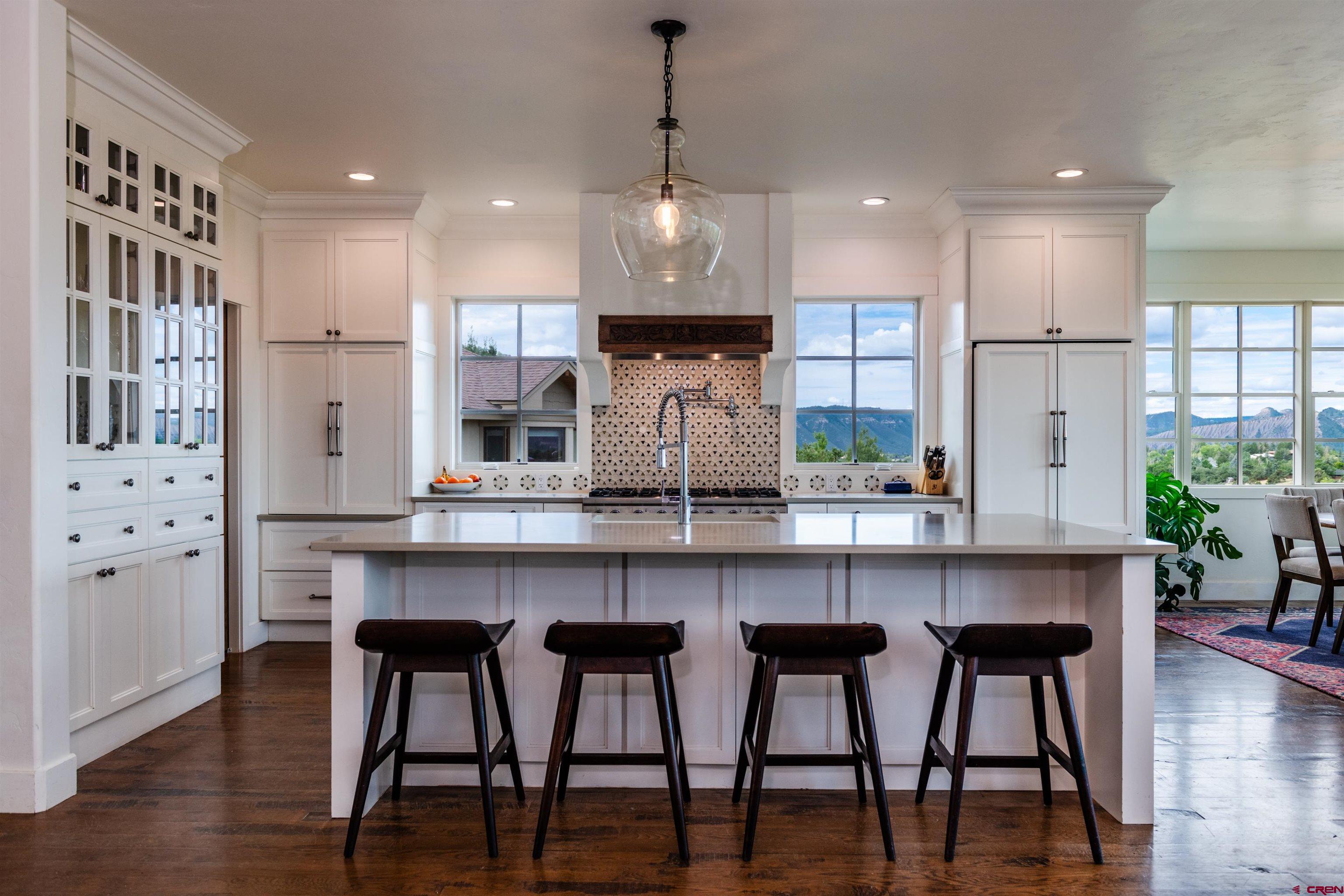 22 Kennebec Drive Durango, CO 81301 - Photo 7 of 34 a kitchen with stainless steel appliances granite countertop a table chairs refrigerator and sink