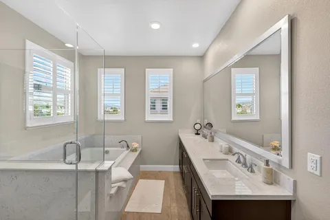 a white bath tub sitting in a bathroom next to a window
