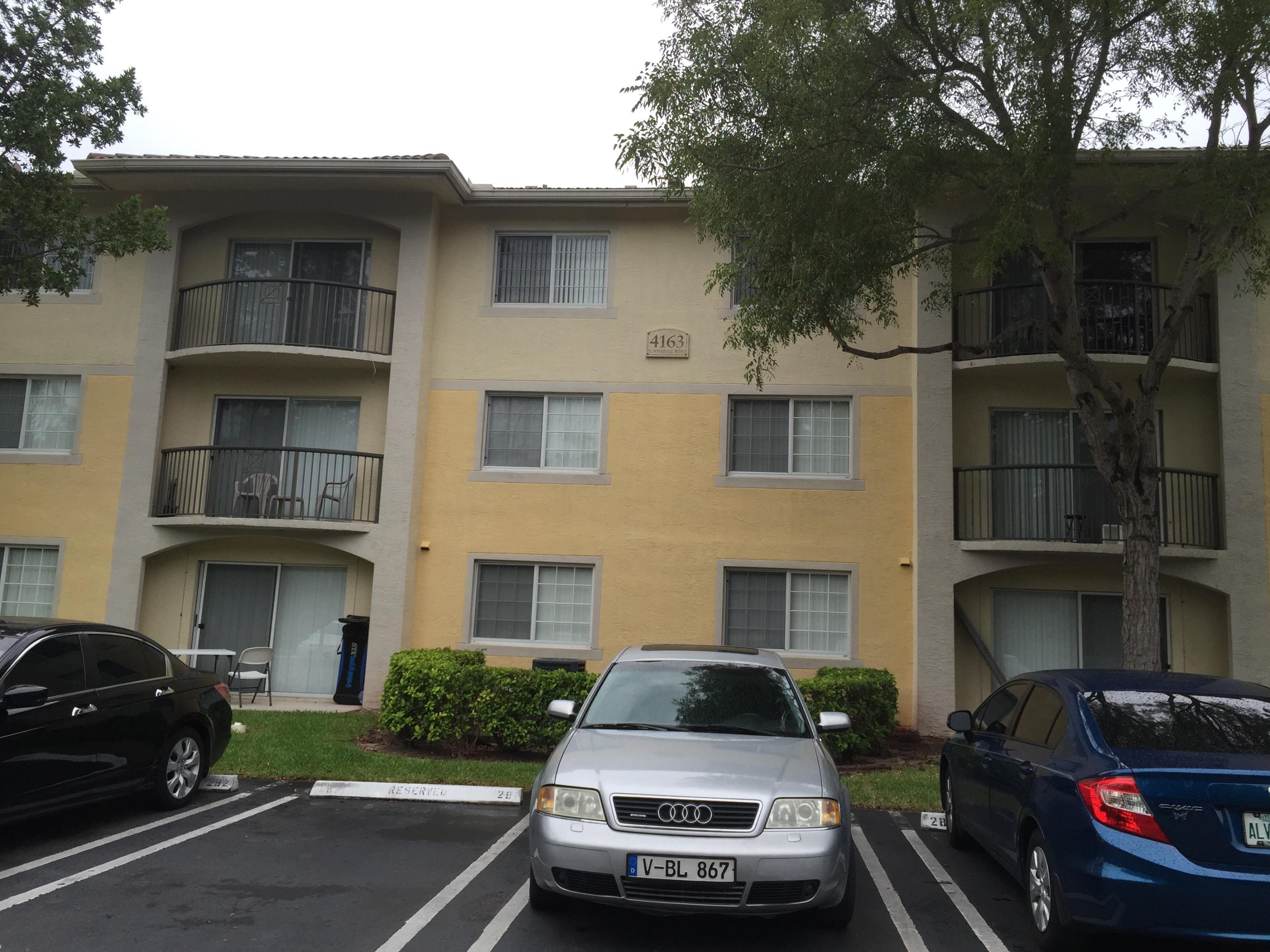 4163 Haverhill Road, Unit 1201 West Palm Beach, FL 33417 - Photo 1 of 1 a car parked in front of a brick house