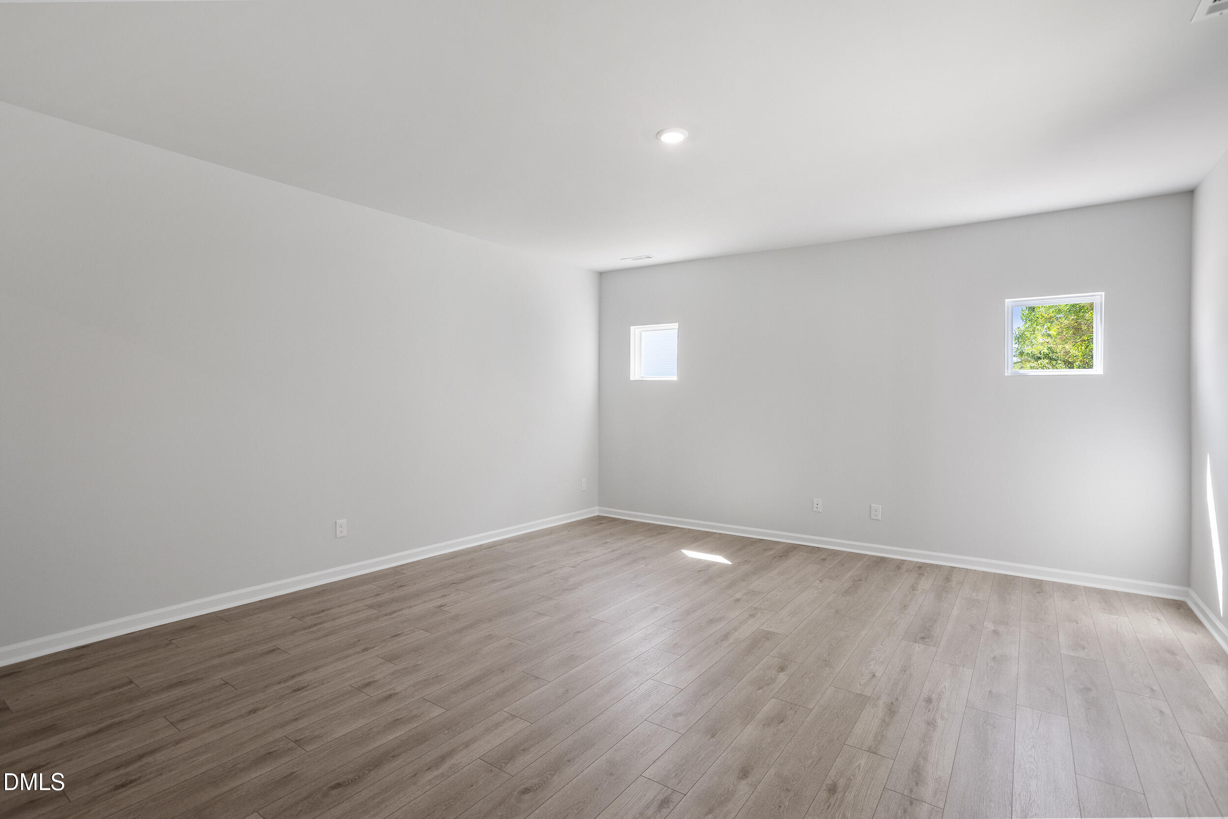 248 Alice Trace Place Angier, NC 27501 - Photo 9 of 32 a view of an empty room with wooden floor and window