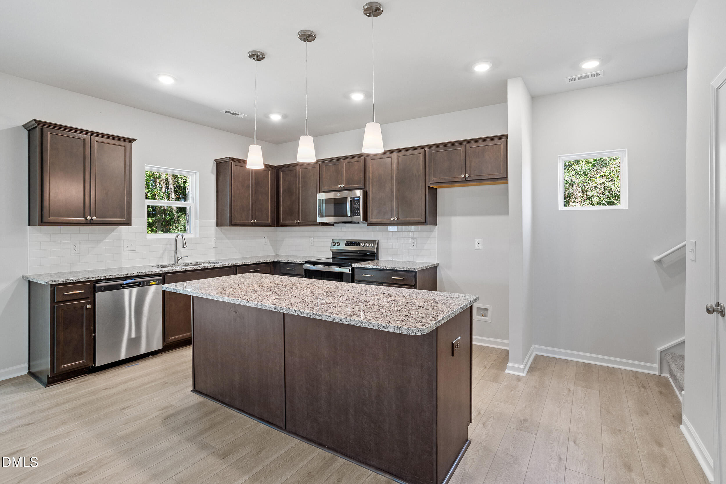 248 Alice Trace Place Angier, NC 27501 - Photo 10 of 32 a kitchen with stainless steel appliances granite countertop a sink stove and refrigerator