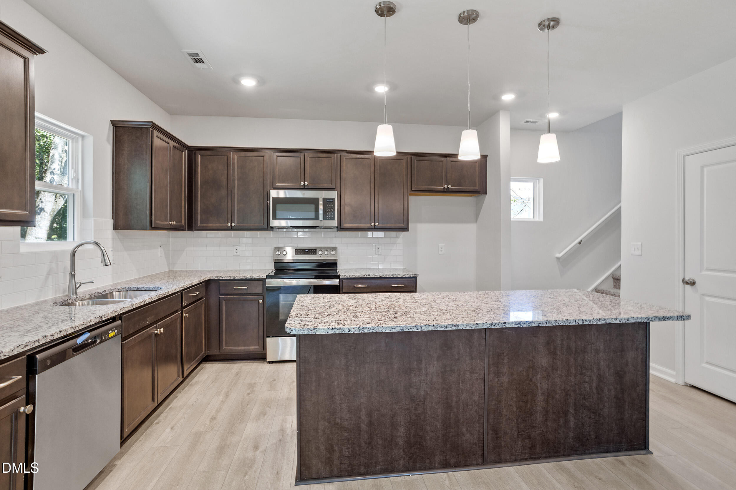 248 Alice Trace Place Angier, NC 27501 - Photo 11 of 32 a large kitchen with granite countertop a sink a counter top space appliances and cabinets