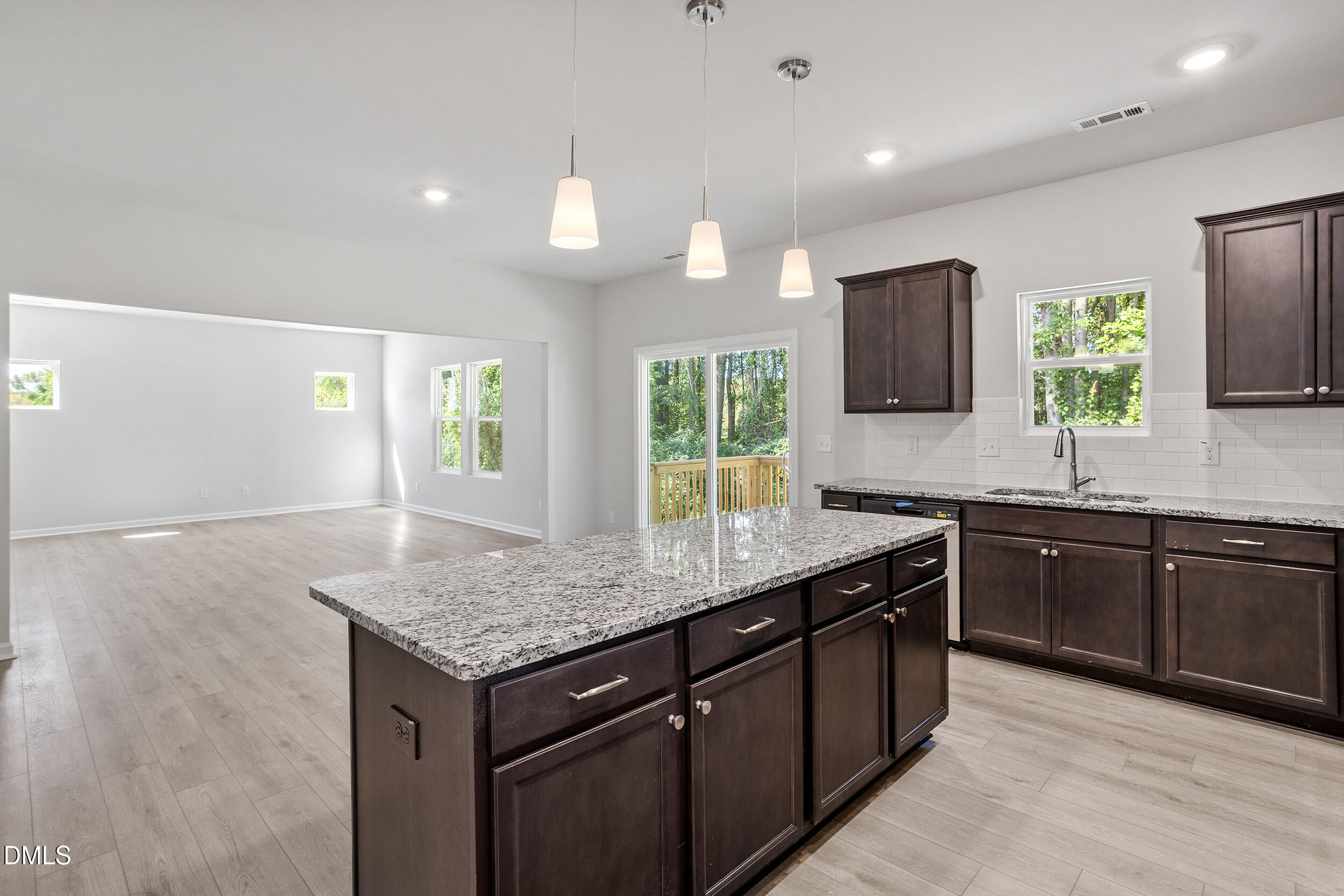 248 Alice Trace Place Angier, NC 27501 - Photo 13 of 32 a kitchen with a center island and some windows