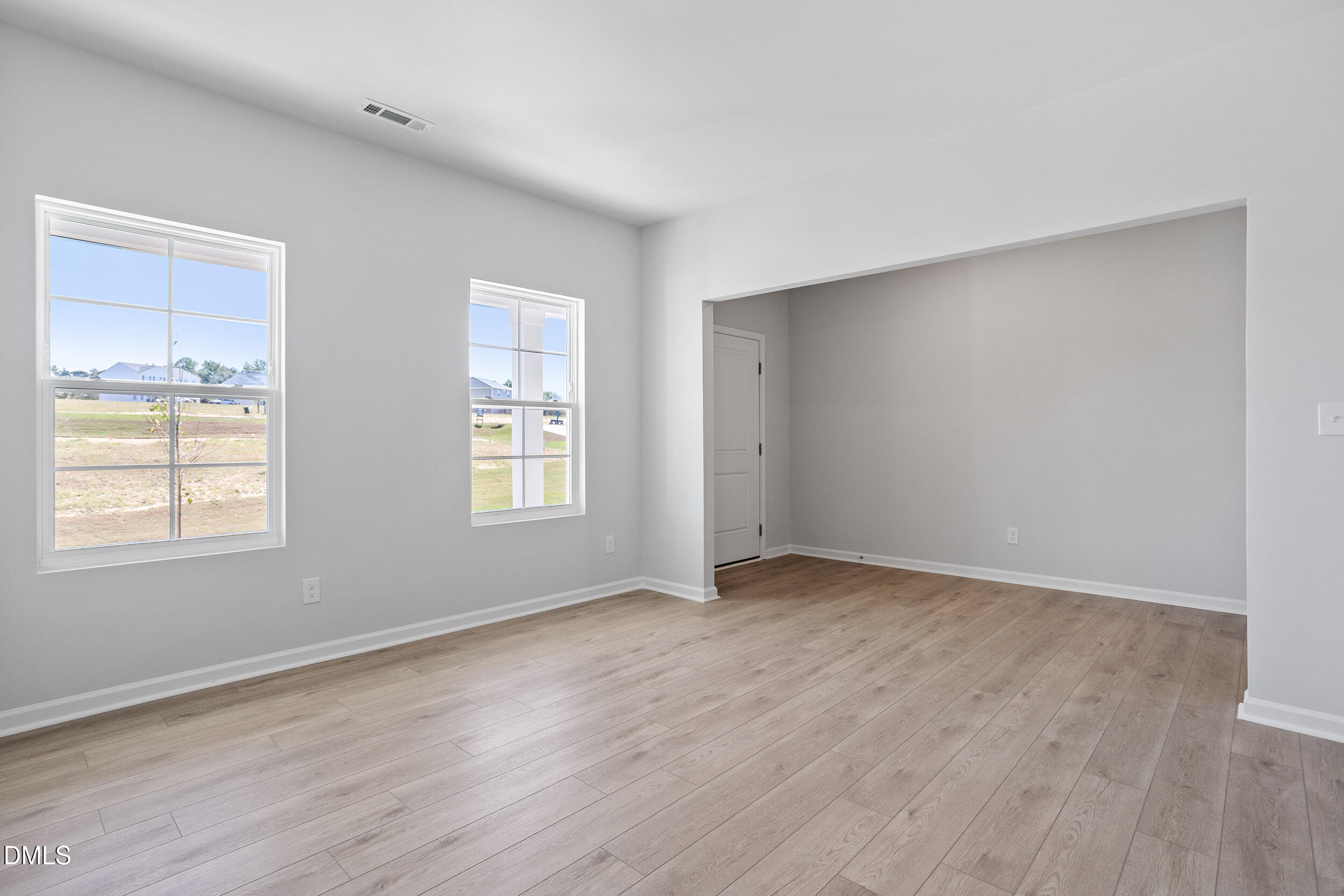 248 Alice Trace Place Angier, NC 27501 - Photo 3 of 32 an empty room with wooden floor and windows