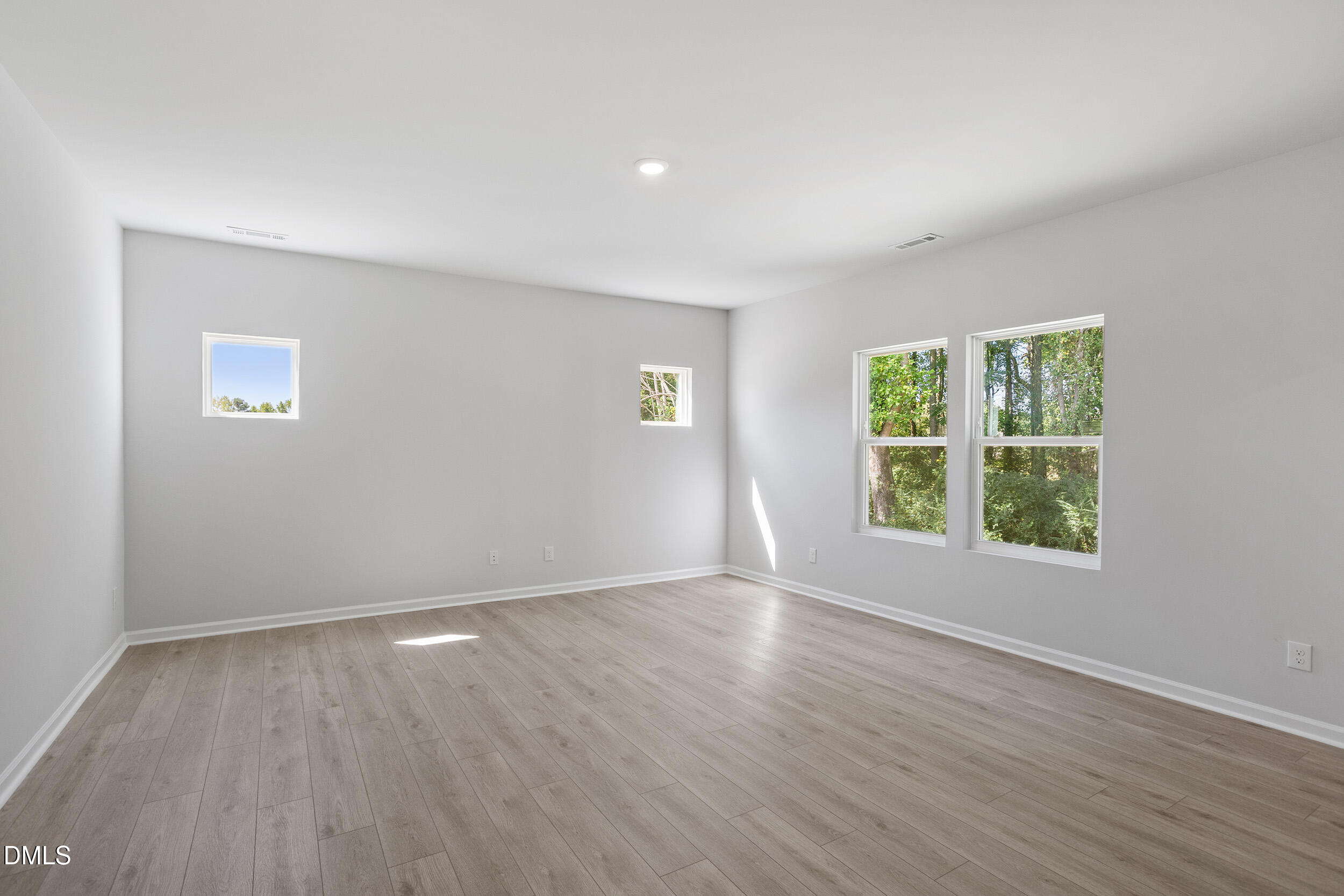 248 Alice Trace Place Angier, NC 27501 - Photo 6 of 32 a view of an empty room with wooden floor and a window