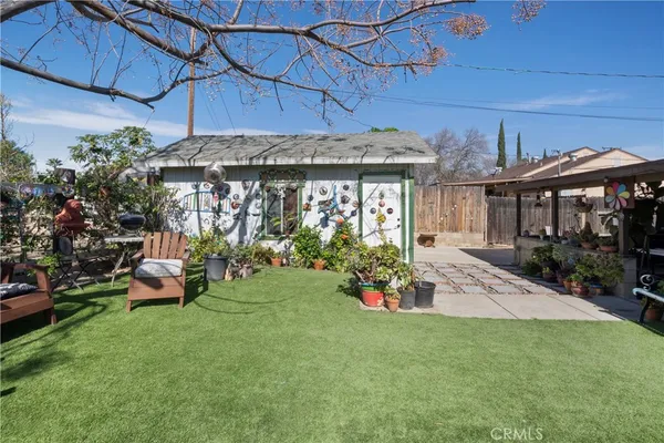 a front view of a house with a garden and patio