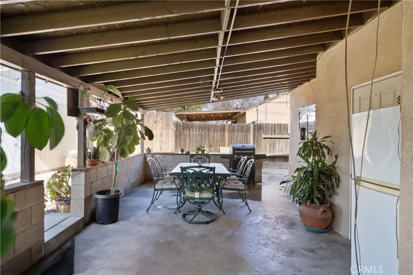 a dining room with furniture and a potted plant