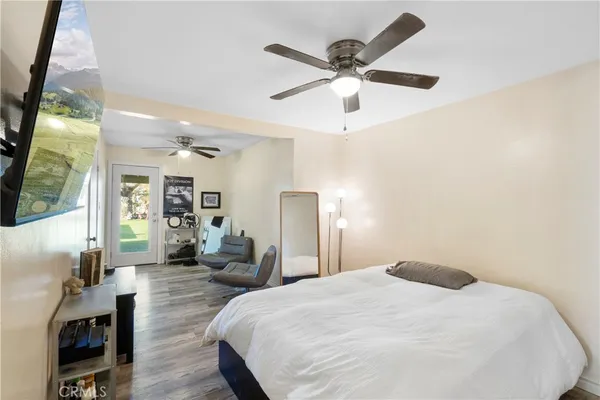 a bedroom with a large bed and a chandelier