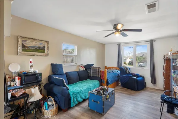 a living room with furniture a chandelier and a window