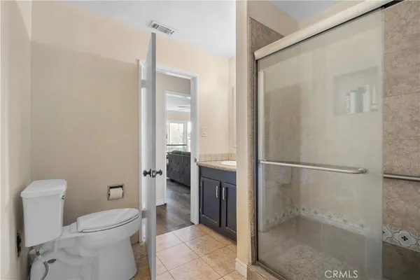 a bathroom with a toilet and a shower