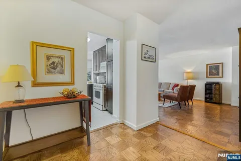 a living room with furniture a lamp and a flat screen tv