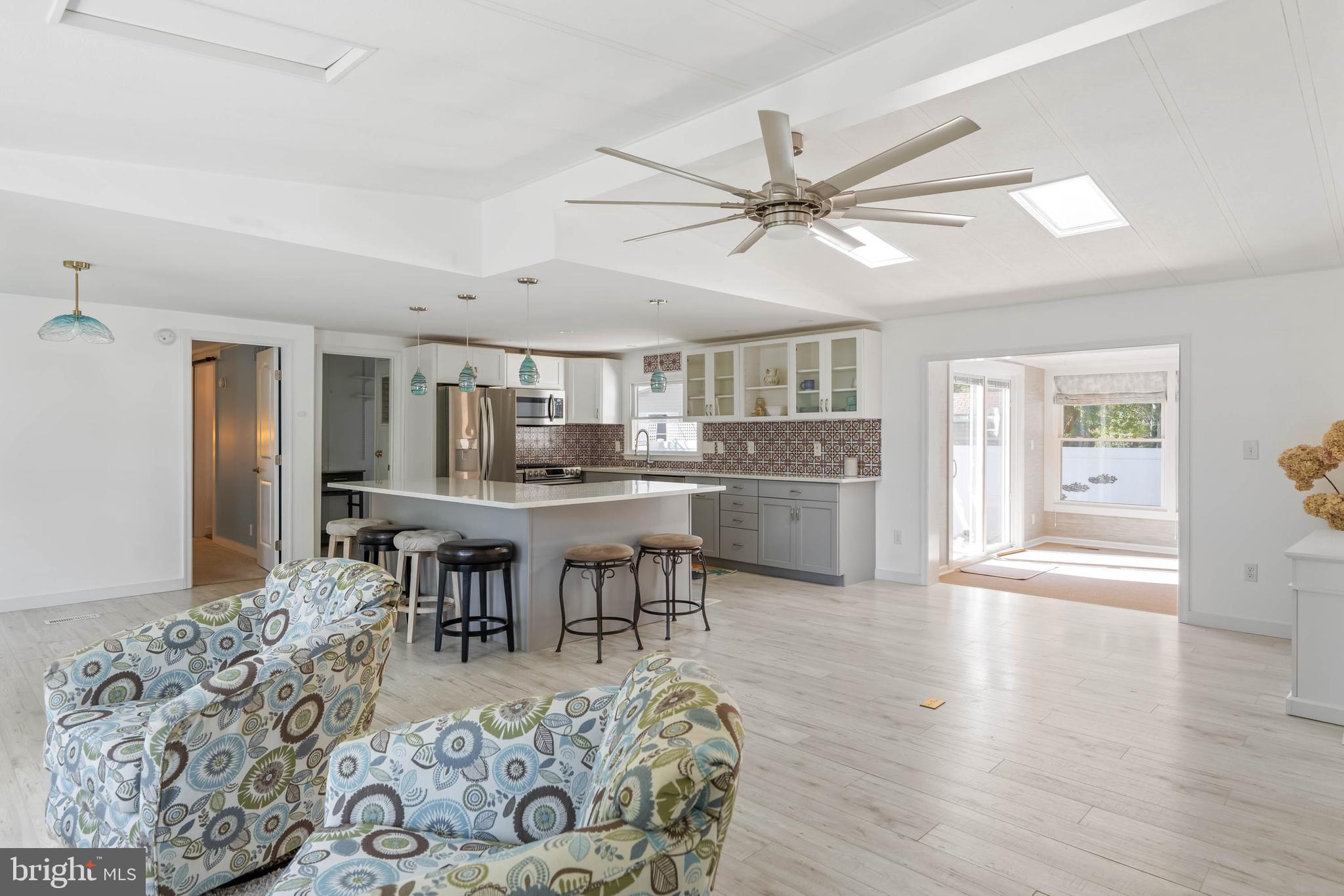 35645 Elk Camp Road Rehoboth Beach, DE 19971 - Photo 13 of 59 a living room with furniture and kitchen view