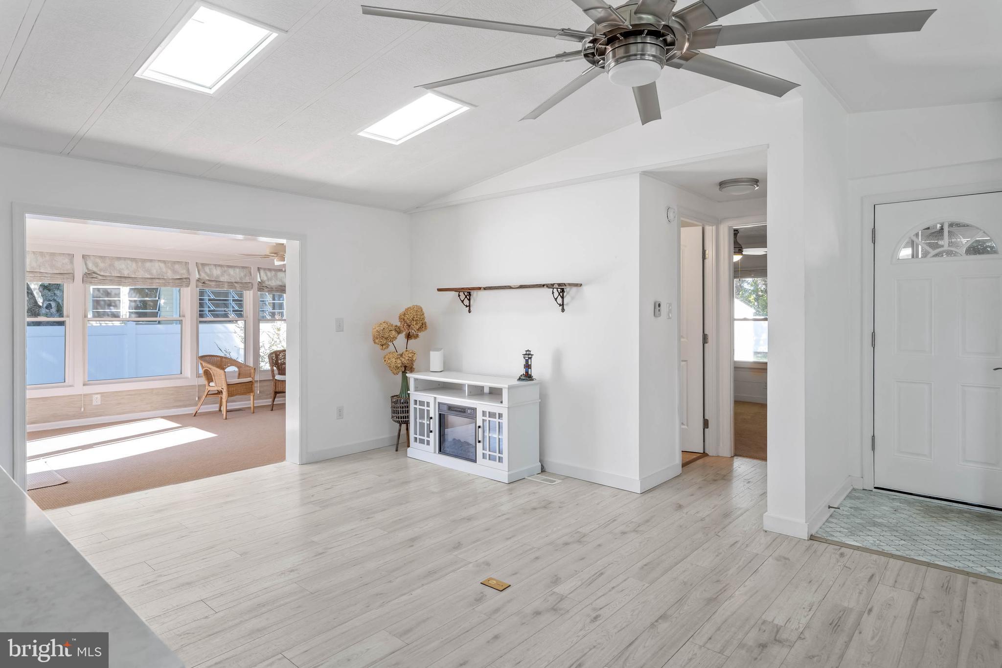 35645 Elk Camp Road Rehoboth Beach, DE 19971 - Photo 17 of 59 wooden floor with white walls and chandelier fan