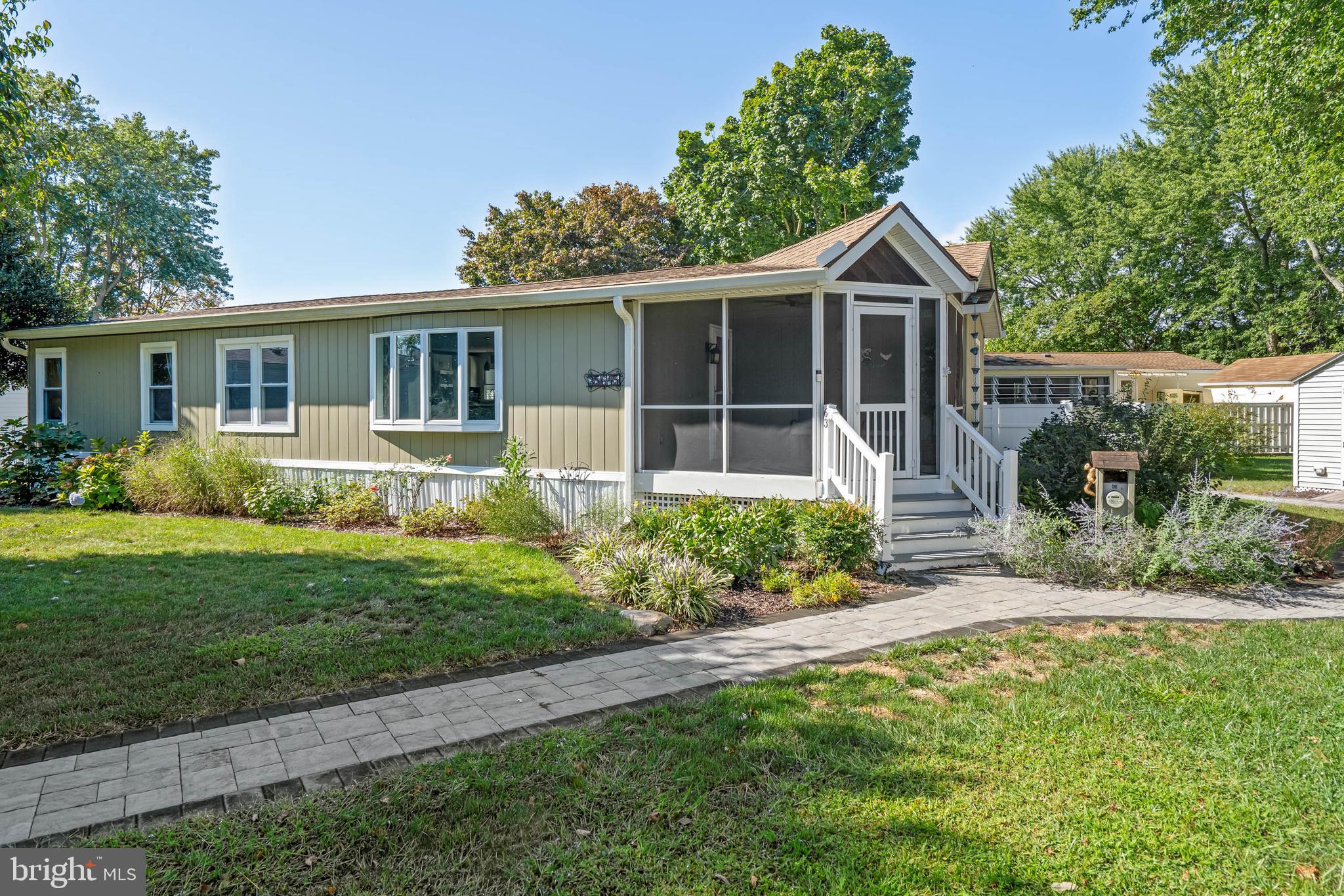35645 Elk Camp Road Rehoboth Beach, DE 19971 - Photo 2 of 59 front view of a house with a yard