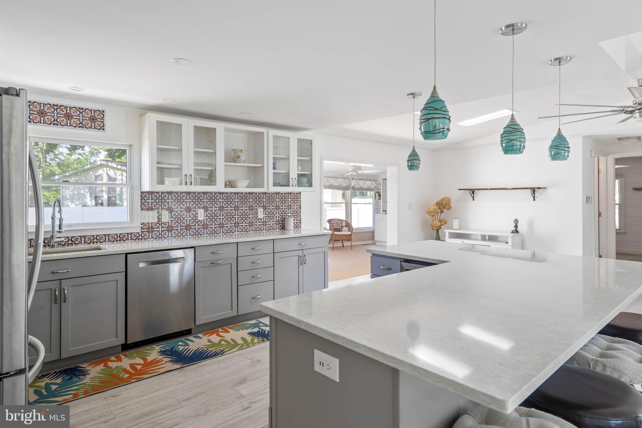 35645 Elk Camp Road Rehoboth Beach, DE 19971 - Photo 21 of 59 a kitchen with stainless steel appliances granite countertop a sink a stove and a refrigerator