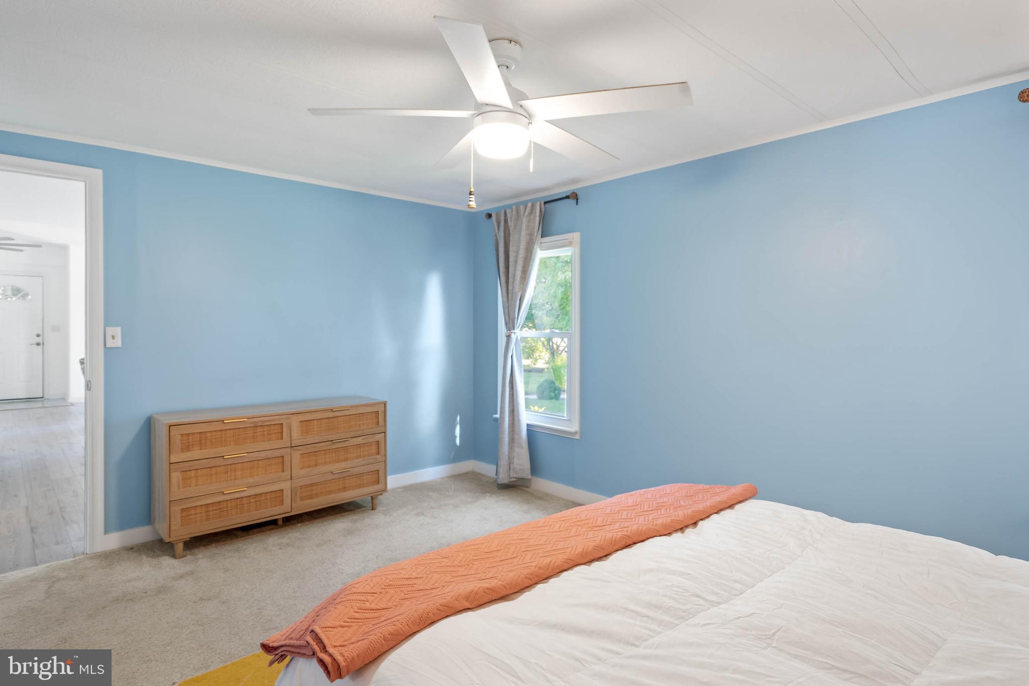 35645 Elk Camp Road Rehoboth Beach, DE 19971 - Photo 25 of 59 a bedroom with a bed and a ceiling fan