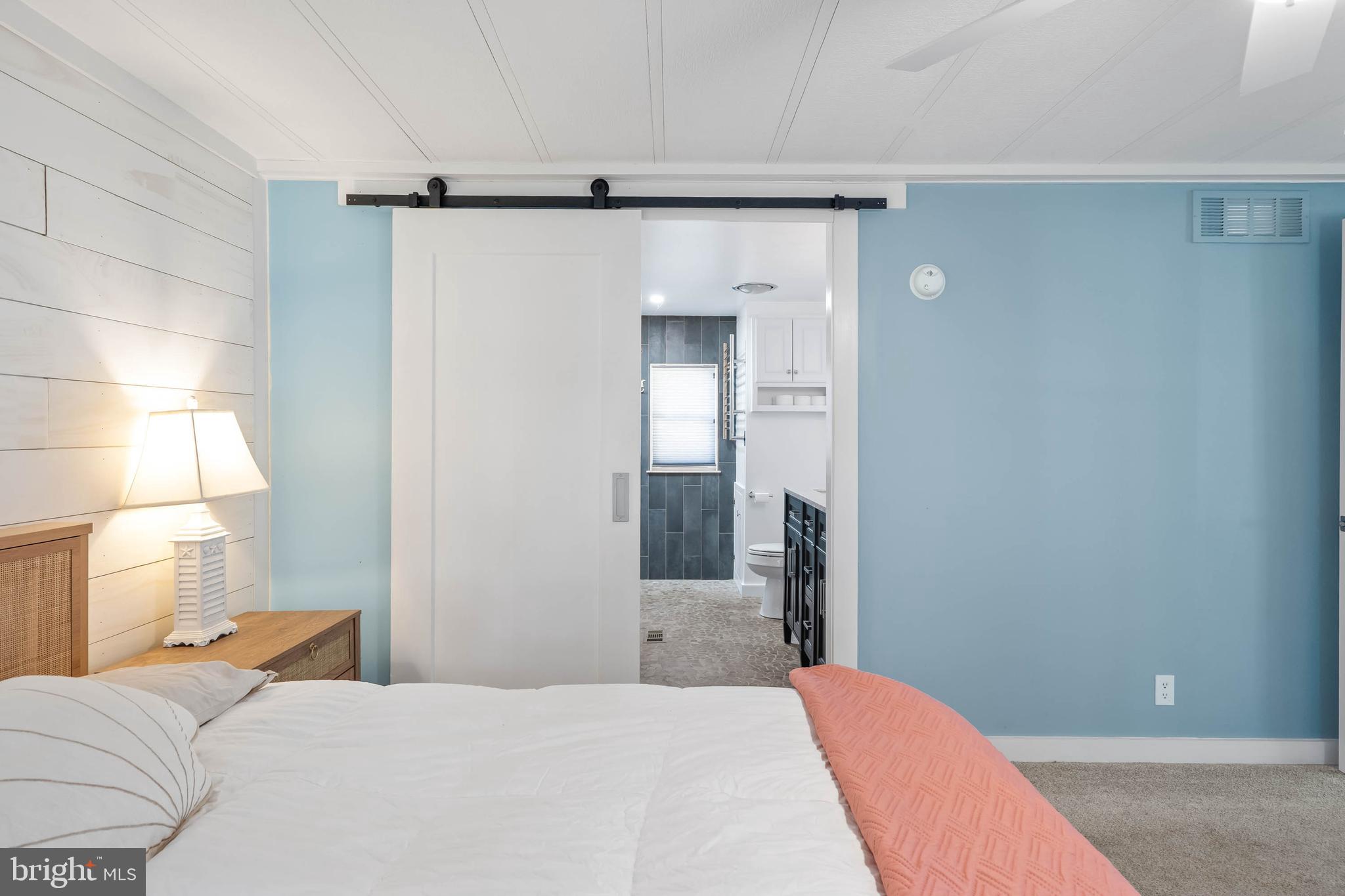 35645 Elk Camp Road Rehoboth Beach, DE 19971 - Photo 28 of 59 a bedroom with a bed and a window