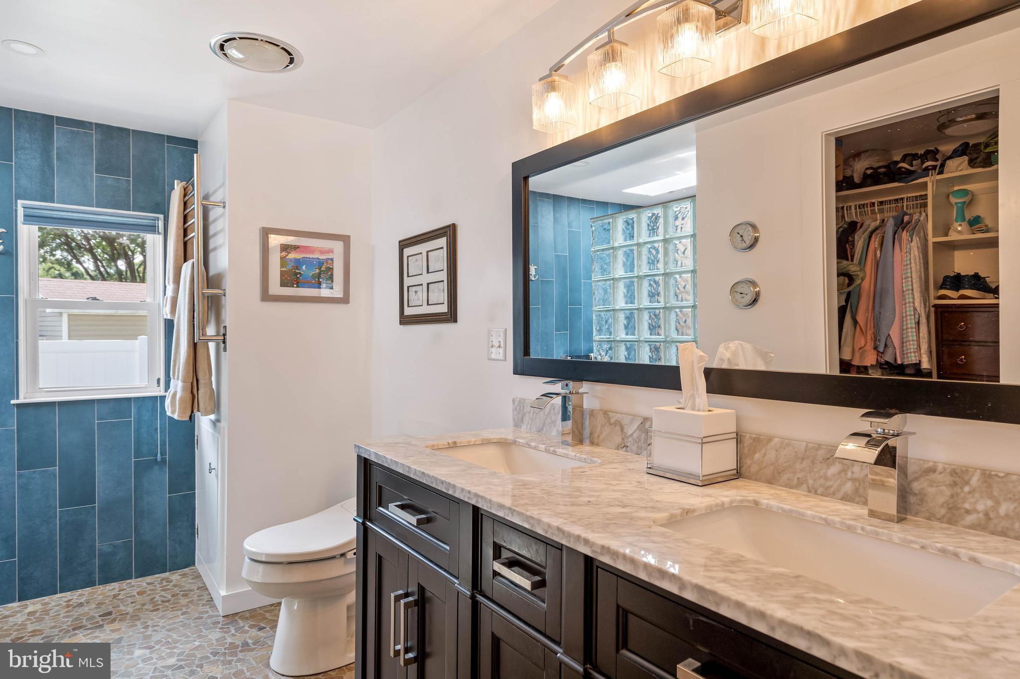 35645 Elk Camp Road Rehoboth Beach, DE 19971 - Photo 29 of 59 a bathroom with a granite countertop toilet sink and mirror