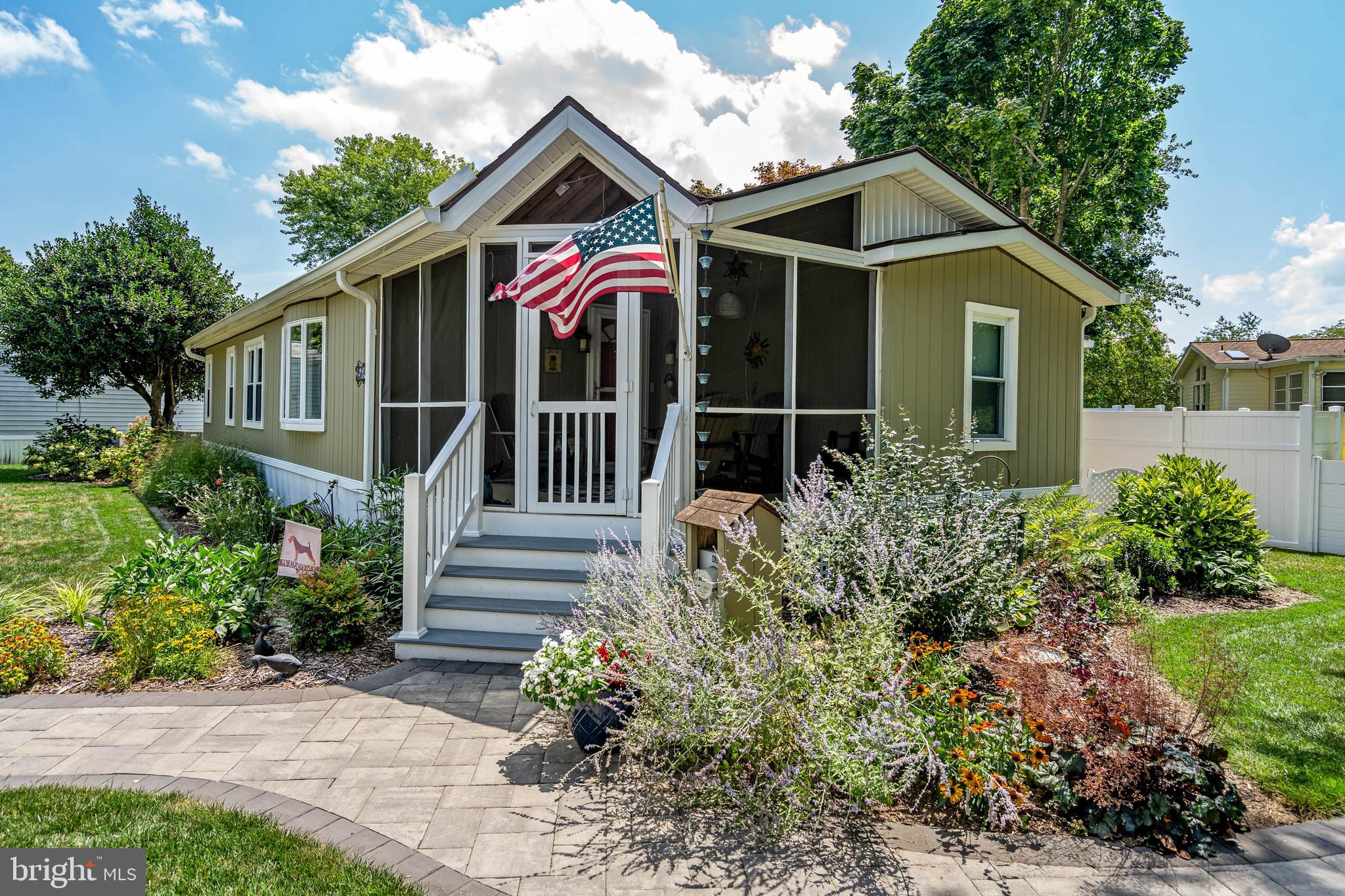 35645 Elk Camp Road Rehoboth Beach, DE 19971 - Photo 3 of 59 a front view of house with yard and green space