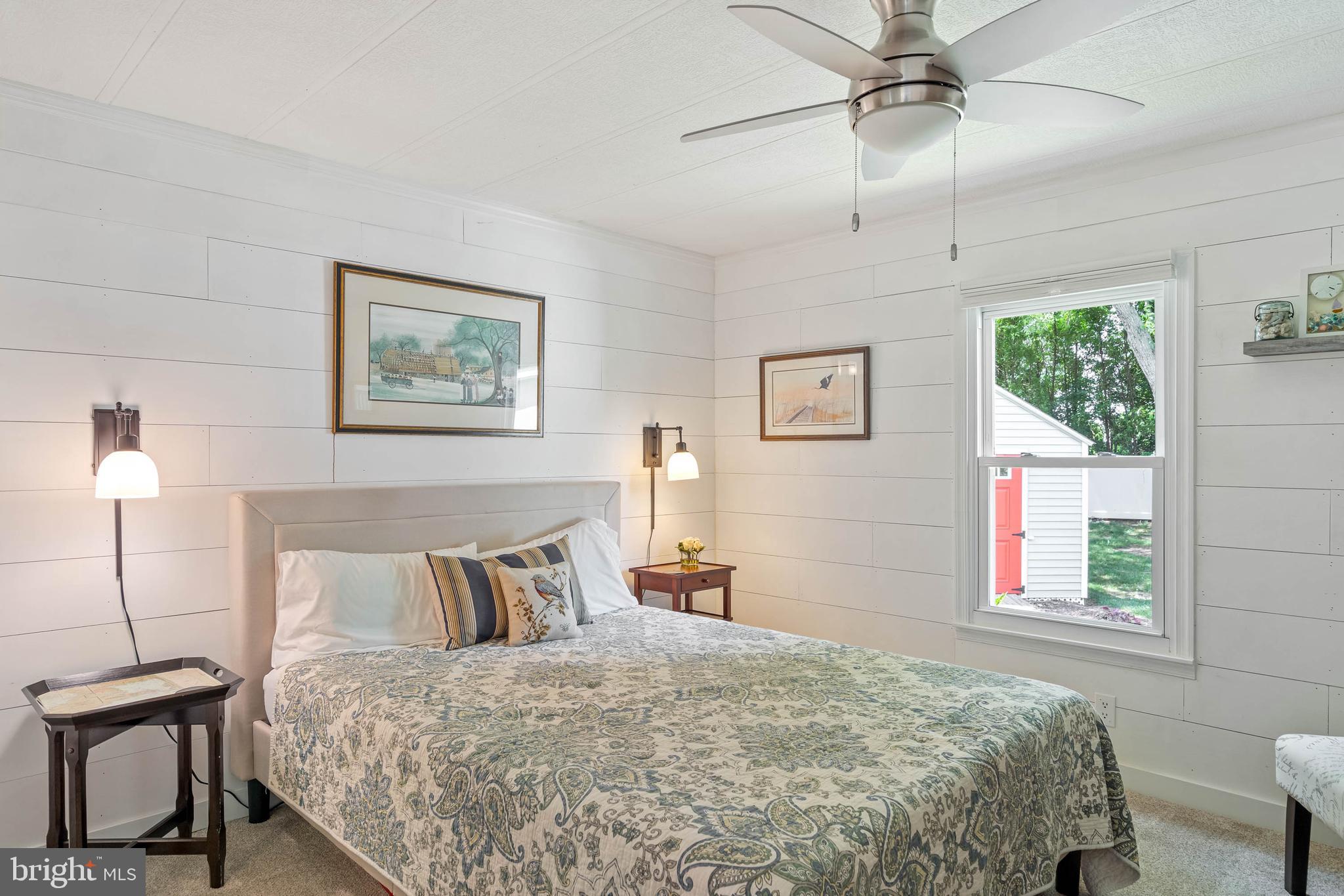 35645 Elk Camp Road Rehoboth Beach, DE 19971 - Photo 36 of 59 a bedroom with a bed and a painting on the wall