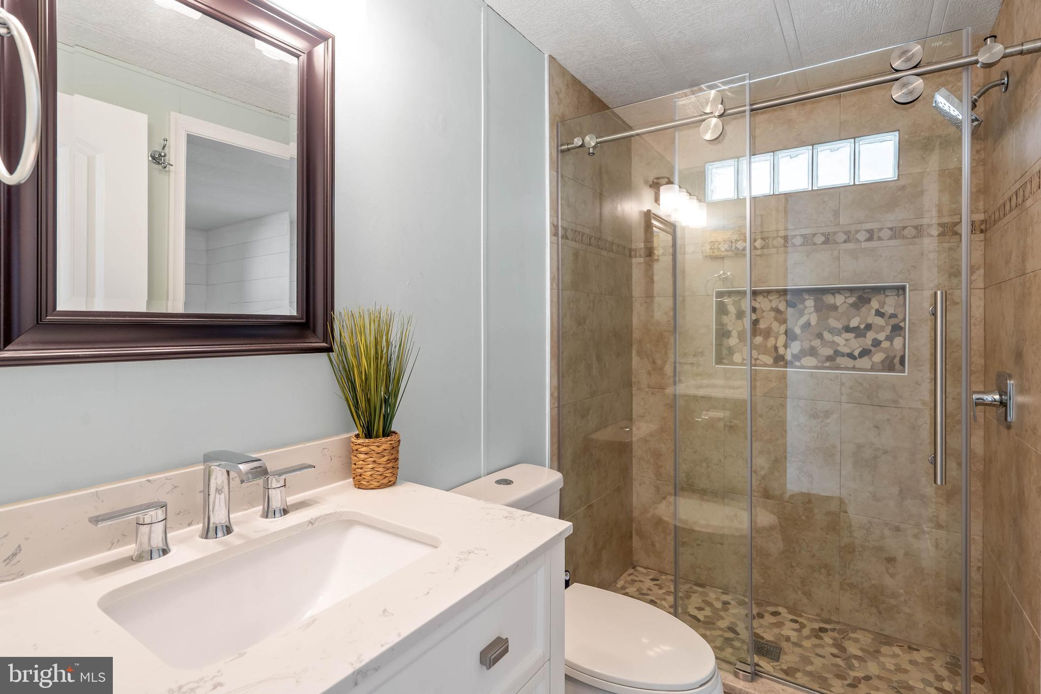 35645 Elk Camp Road Rehoboth Beach, DE 19971 - Photo 39 of 59 a bathroom with a sink toilet and shower