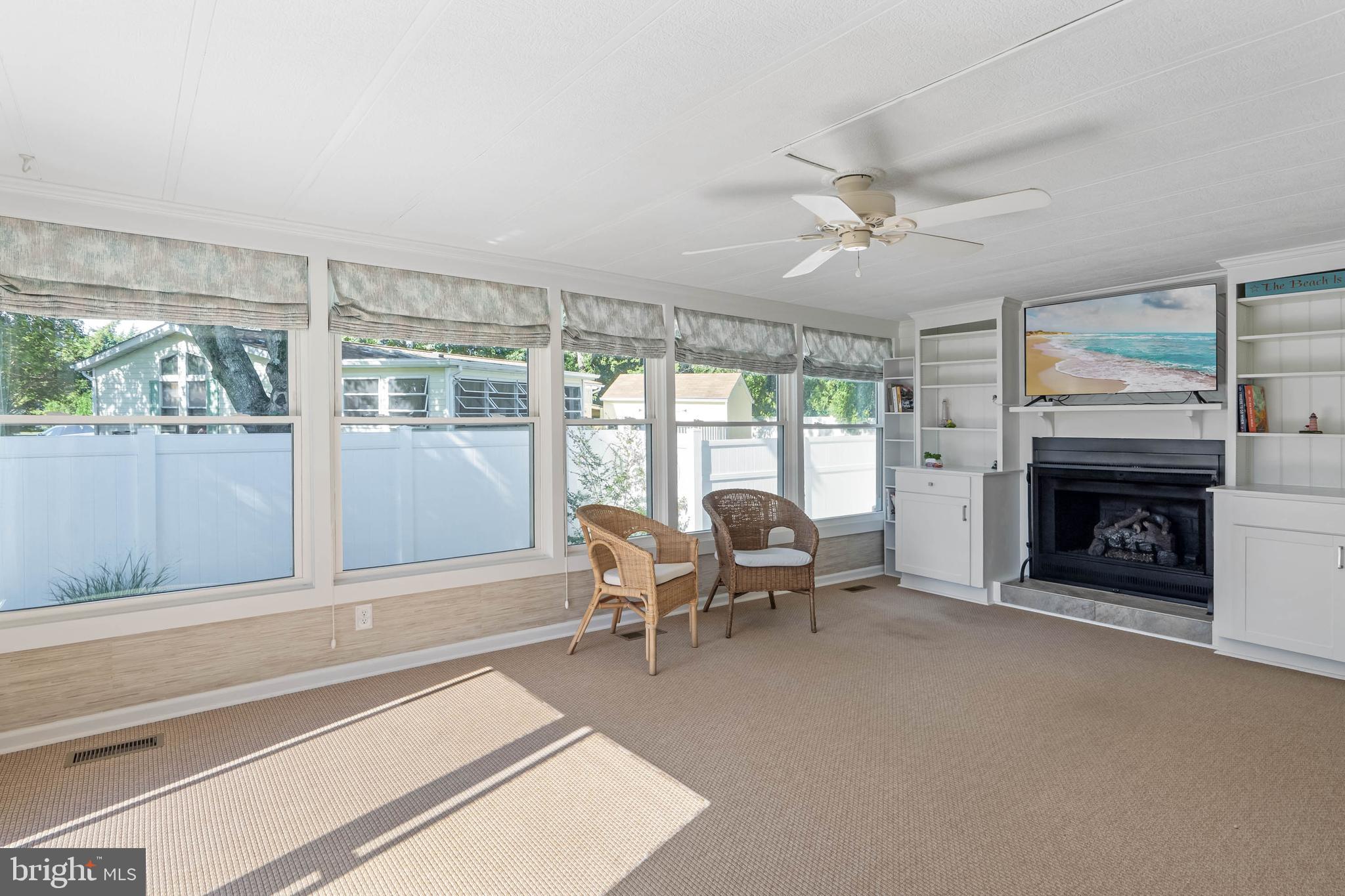 35645 Elk Camp Road Rehoboth Beach, DE 19971 - Photo 40 of 59 a living room with furniture and a fireplace
