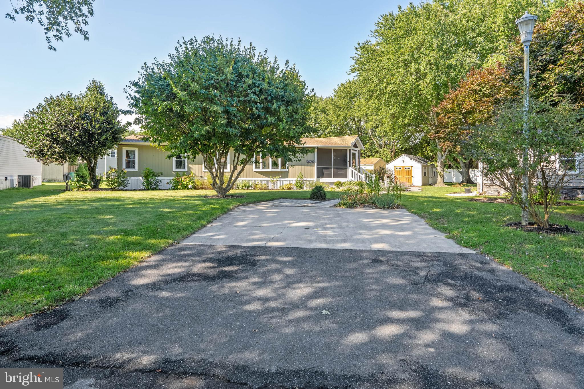 35645 Elk Camp Road Rehoboth Beach, DE 19971 - Photo 46 of 59 a front view of a house with a yard and trees