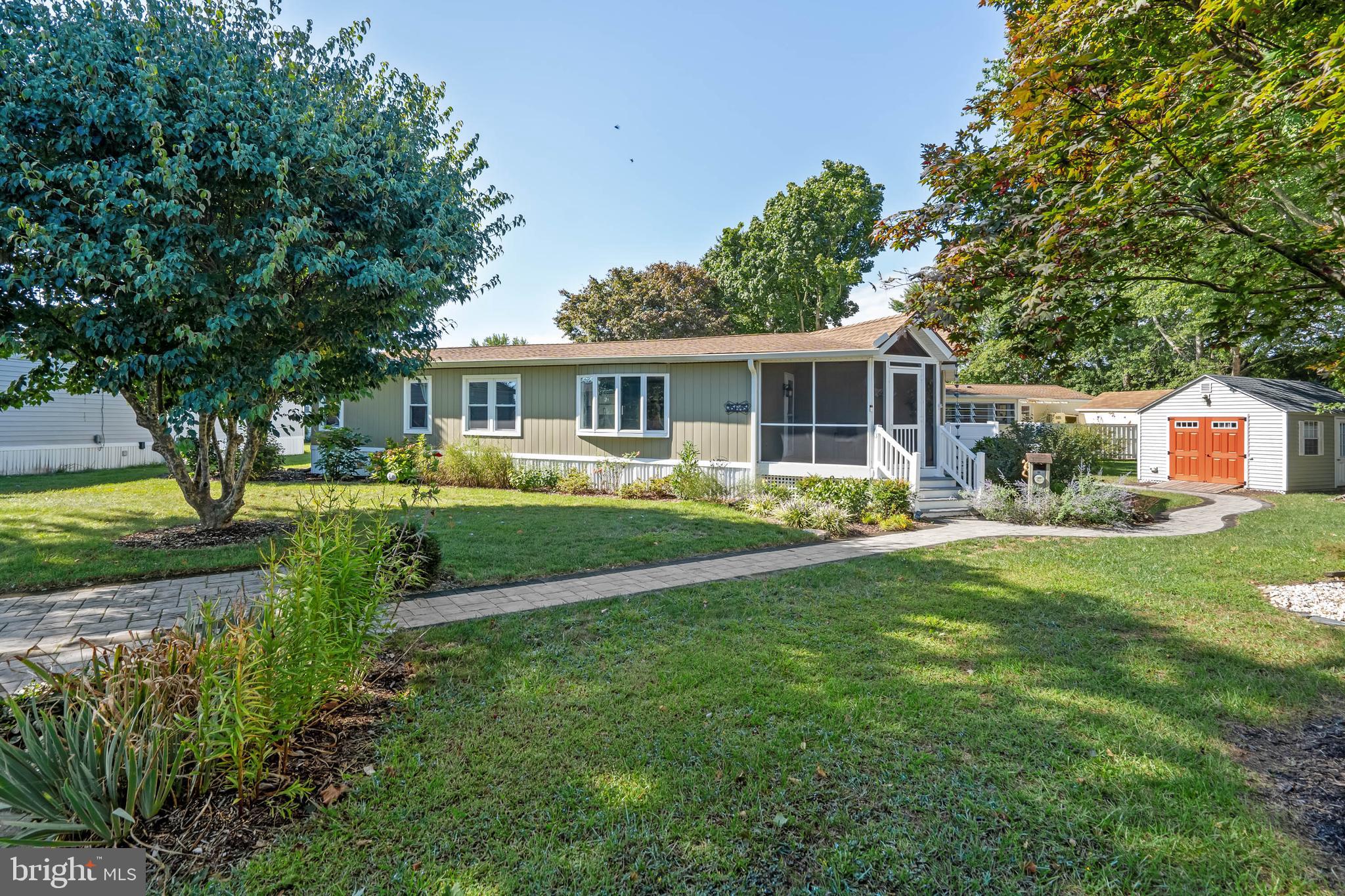 35645 Elk Camp Road Rehoboth Beach, DE 19971 - Photo 48 of 59 a front view of a house with a yard table and chairs