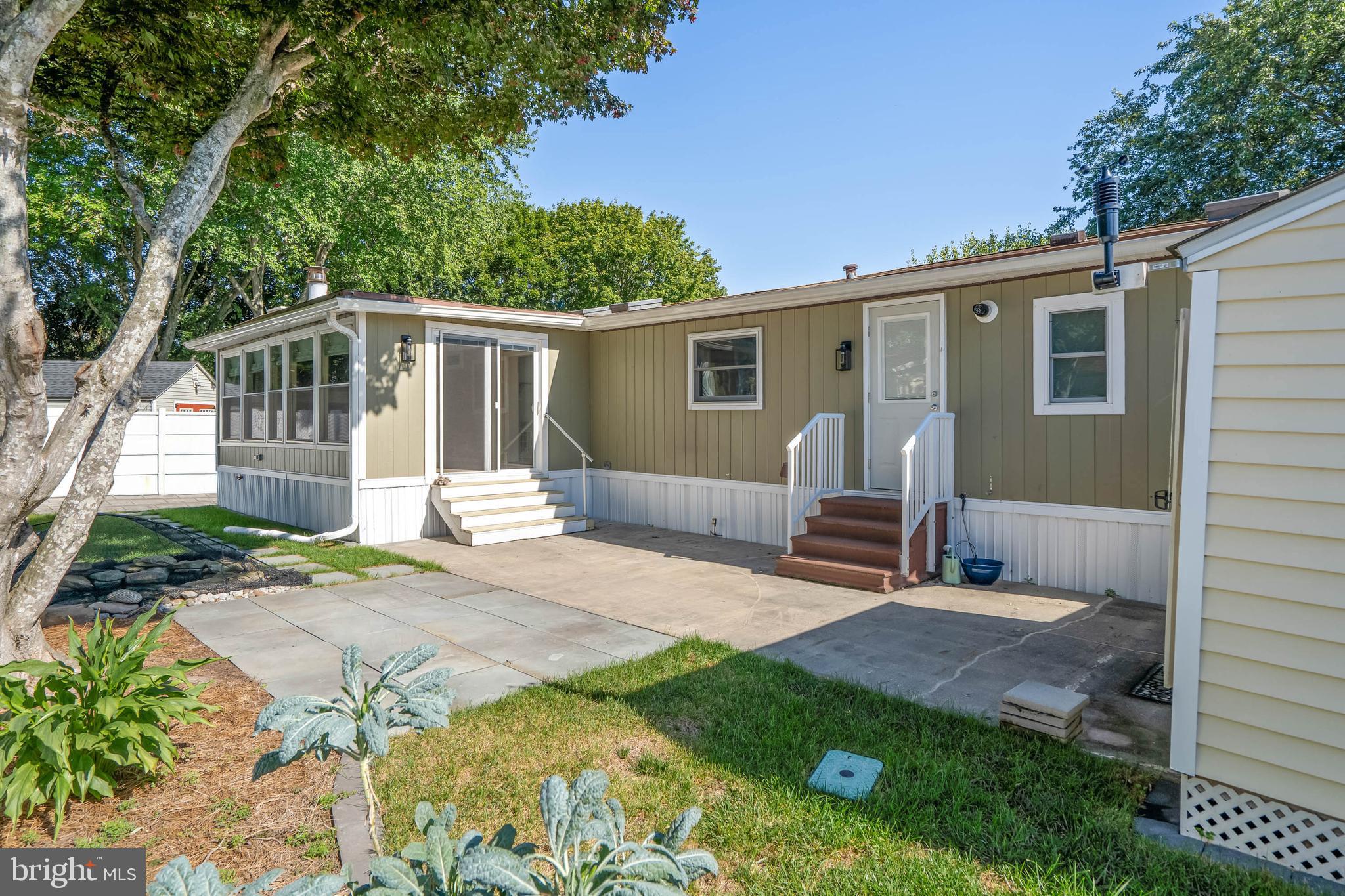 35645 Elk Camp Road Rehoboth Beach, DE 19971 - Photo 55 of 59 a view of a house with backyard and a tree