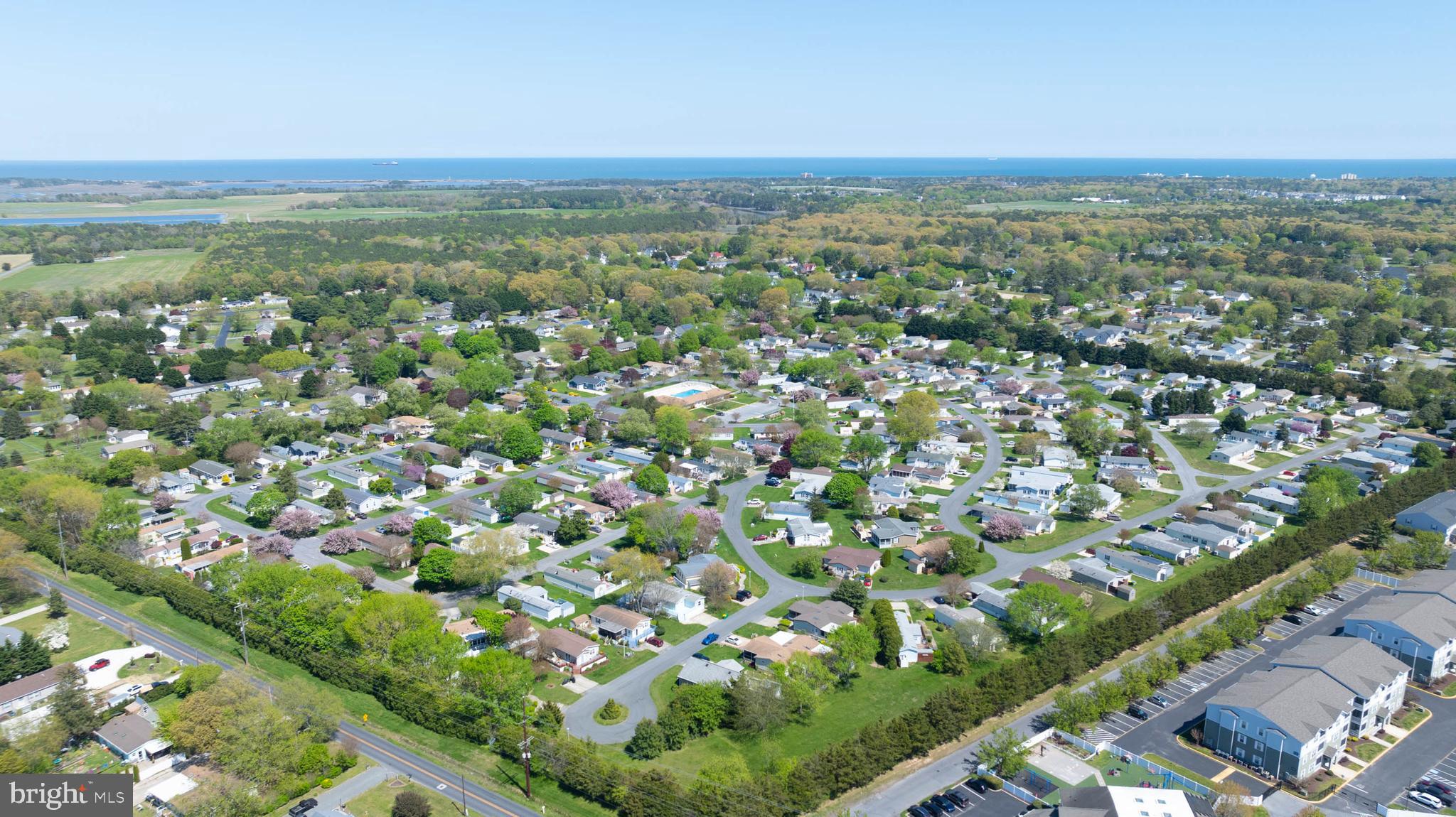 35645 Elk Camp Road Rehoboth Beach, DE 19971 - Photo 58 of 59 an aerial view of residential houses with outdoor space and trees