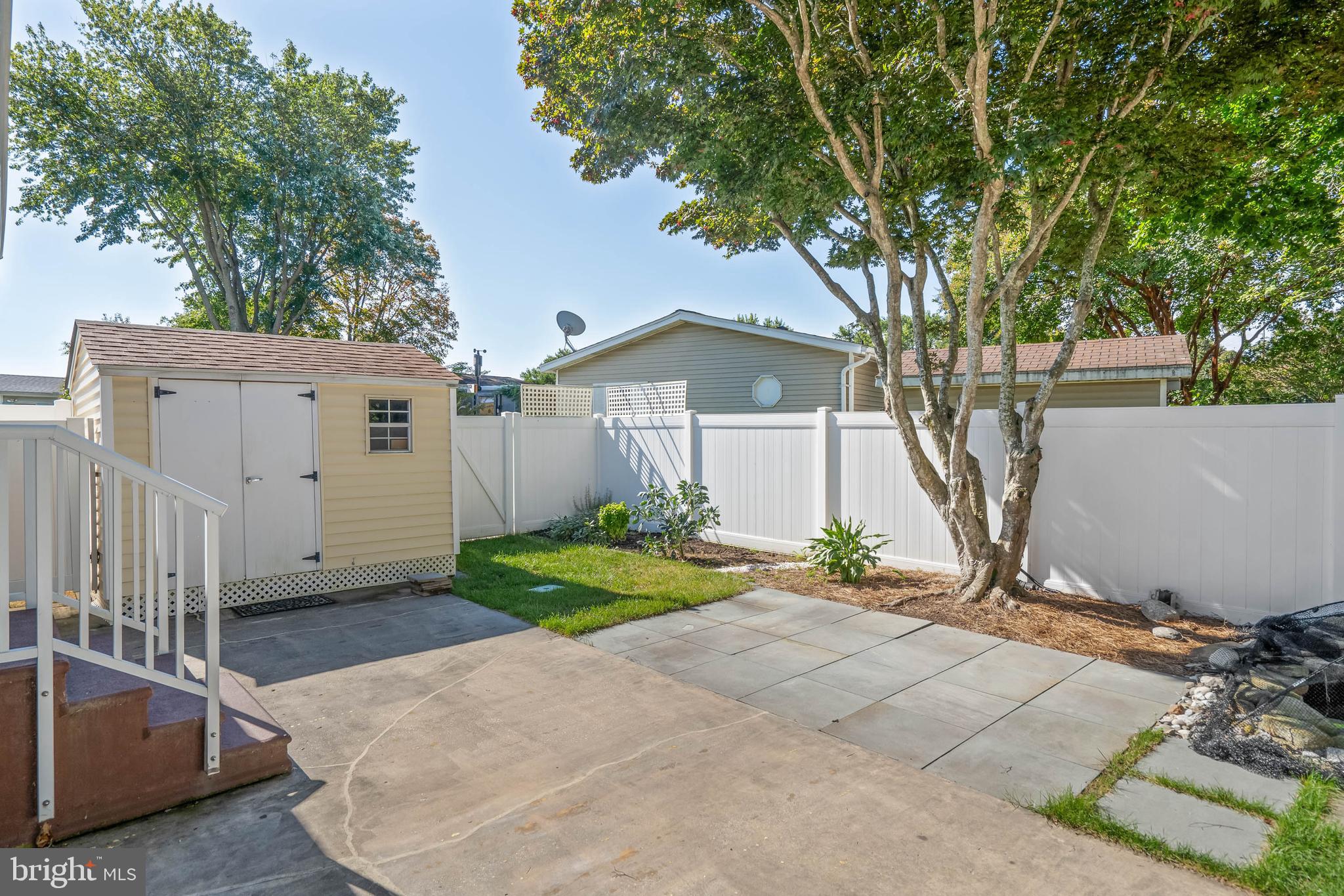 35645 Elk Camp Road Rehoboth Beach, DE 19971 - Photo 10 of 59 a front view of a house with a yard and garage