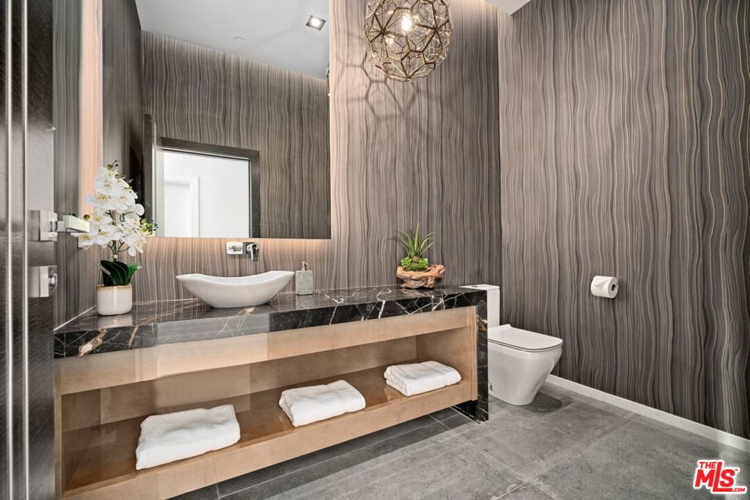 11241 Blix Street Toluca Lake, CA 91602 - Photo 11 of 19 a bathroom with a granite countertop sink and a mirror