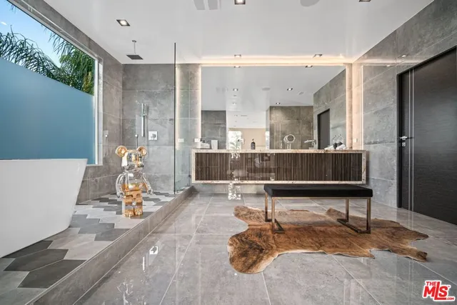 a bedroom with a large bed and a large window