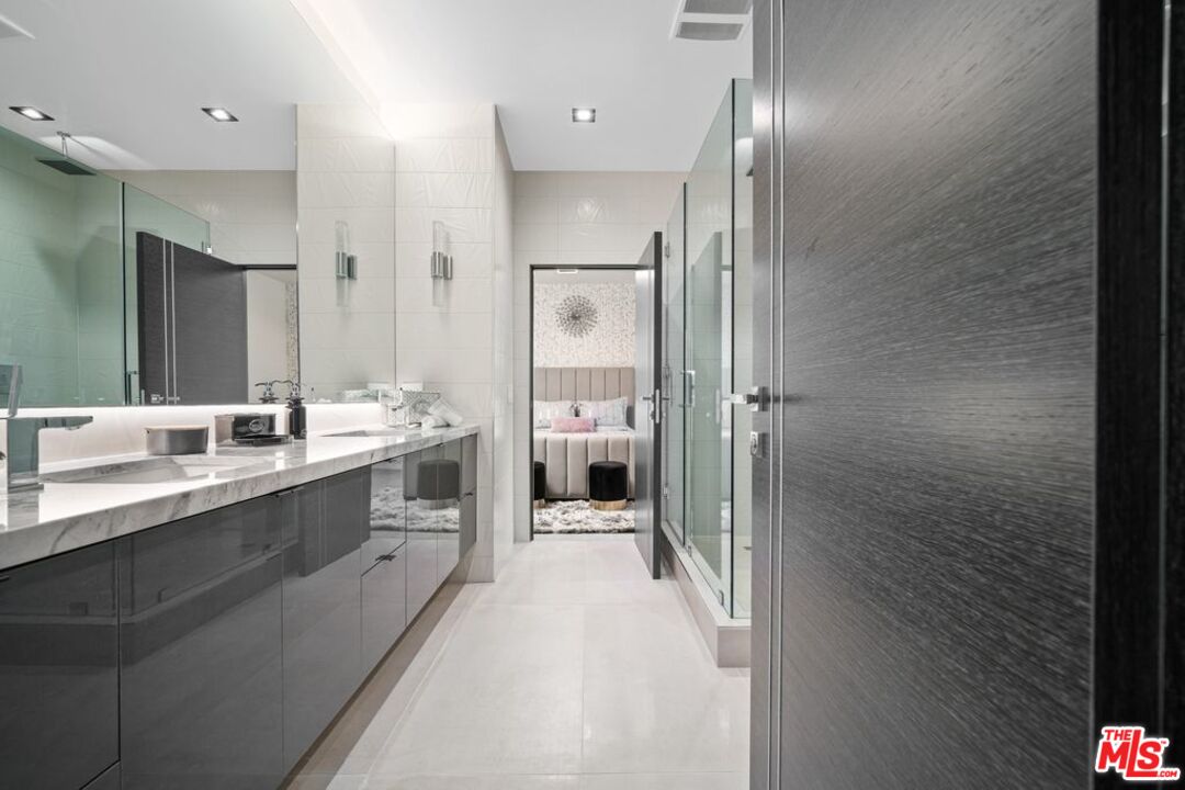 11241 Blix Street Toluca Lake, CA 91602 - Photo 16 of 19 a bathroom with a sink a toilet and shower