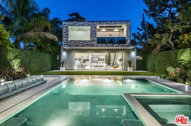 a view of a swimming pool with chairs in patio